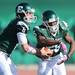 Eastern Michigan junior Alex Gillett looks to hand the ball off to junior Dominique Sherrer during the second half against Western Michigan at Rynearson Stadium on Saturday afternoon. Melanie Maxwell I AnnArbor.com
